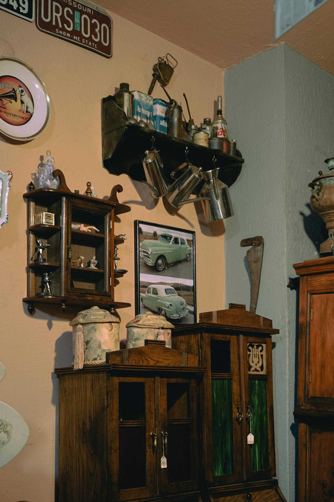 A nostalgic collection of vintage items displayed on wooden shelves, featuring license plates and antique decor.